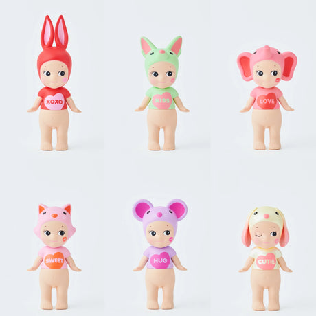 The Sonny Angel Bundle - Kiss Kiss Blind Box + Tote by Sonny Angel features six dolls in colorful animal hats and shirts with "XOXO," "KISS," and "LOVE" heart prints, arranged in two rows—perfectly paired with an embroidered tote bag.