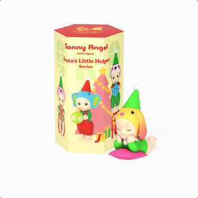 Mini vinyl elf figure in green hat and red outfit, beside blind box packaging