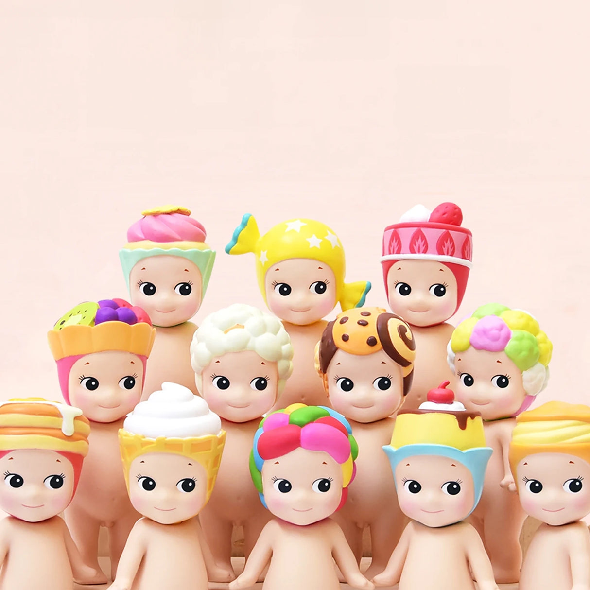 A set of figurines from the Sonny Angel Sweets Series Blind Box by Sonny Angel is organized in rows, each adorned with pastel-colored, food-themed hats. Ideal for collectors, these charming figures are typically revealed as surprises within blind boxes.