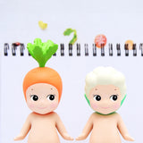 These Sonny Angel Vegetable Series Blind Box figures showcase two adorable characters wearing carrot and cauliflower-themed hats on a white backdrop, highlighted by small food illustrations above.