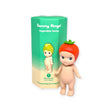 A cute figurine with a tomato hat stands proudly next to its packaging from the "Sonny Angel Vegetable Series Blind Box," part of the adorable lineup by Sonny Angel.