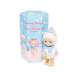 A small bear-themed figurine dressed in a winter outfit stands next to a blue box with snowflake patterns, labeled "Sonny Angel Winter Wonderland Series" from the Sonny Angel brand.