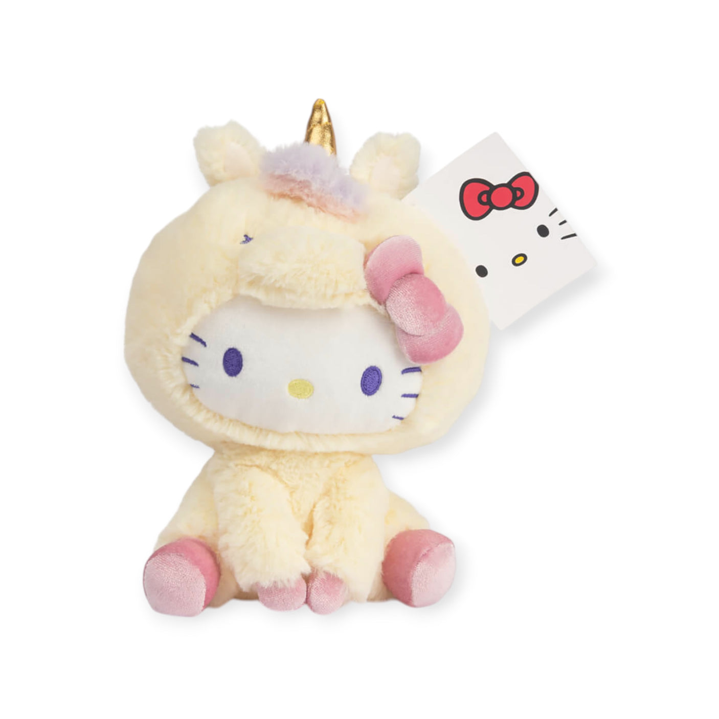 The Hello Kitty Plush - Unicorn by Hello Kitty is a magical gift idea, showcasing a plush toy dressed in a unicorn costume complete with an attached tag. It features a white face and charming pink accents on its paws and bow for an enchanting appeal.