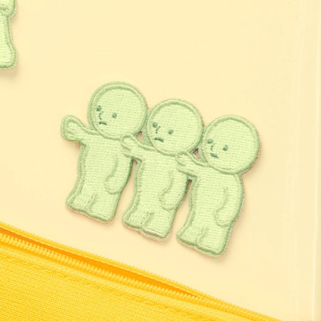 Light green embroidered character patch with three stacked cute faces and stitched details