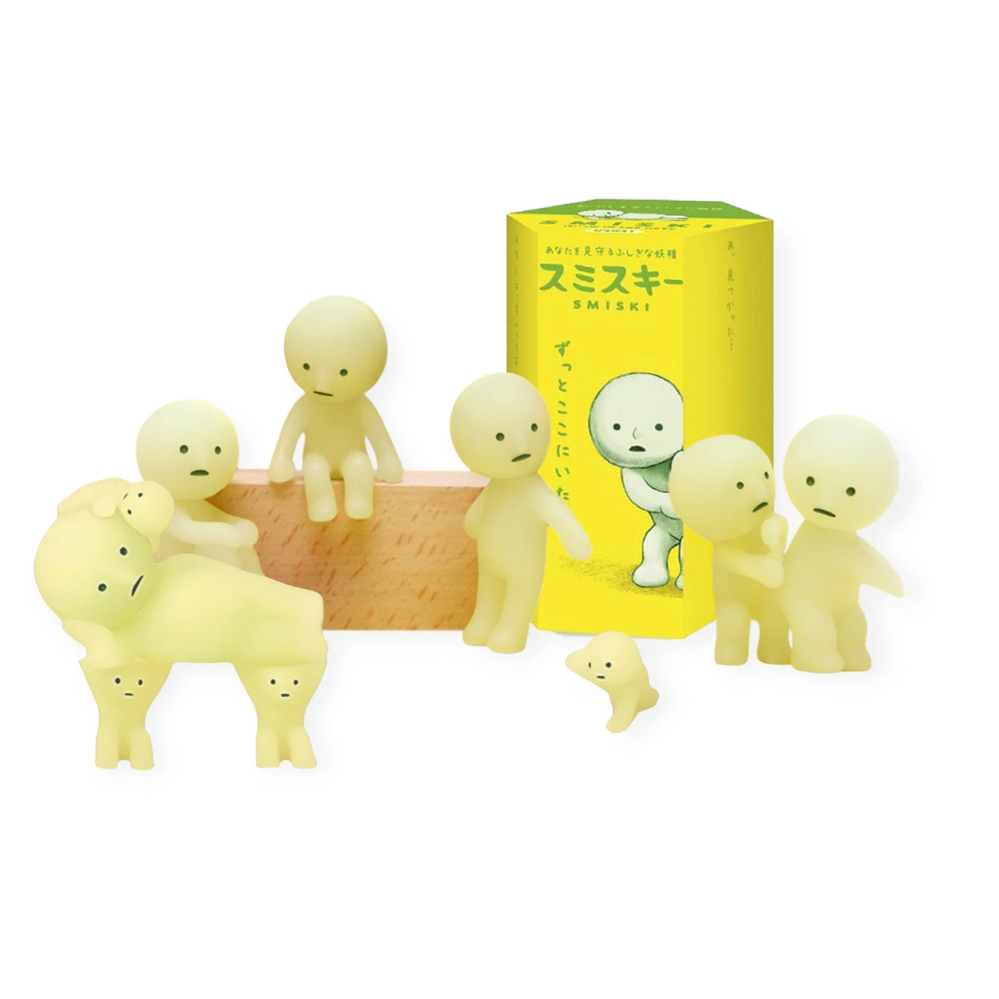 A collection of Smiski Series 1 figurines from the Smiski brand, which features a glow-in-the-dark design, is presented alongside its blind box.