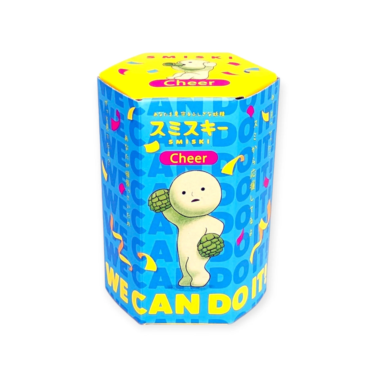 This hexagonal container, adorned in blue and yellow, showcases a cartoon character, confetti, and includes the phrases "Cheer" and "We Can Do It" written in both English and Japanese. It belongs to the Smiski Cheer Series - Blind Box collection by Smiski, with each mystery figure offering a glow-in-the-dark feature.