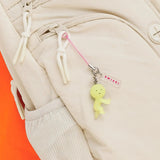 Light green Smiski strap keychain charm with pink cord, metal ring, and SMISKI tag