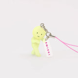 Lemon-green Smiski keychain figure with pink lanyard strap and small charm tag