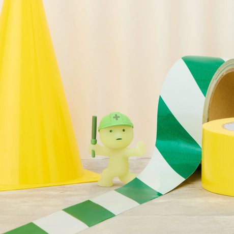 Small yellow-green construction figure with green hard hat and holding a tool