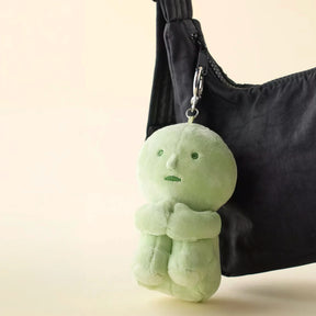 Green plush Smiski keychain hugging knees with metal ring and clip