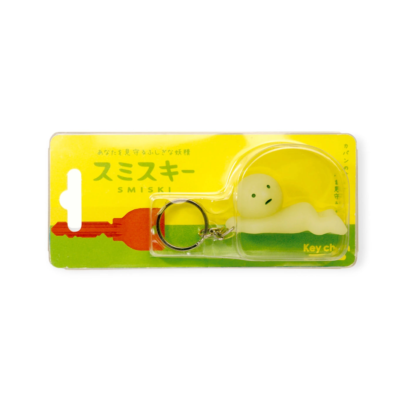 The packaging of the Smiski Keychain - Grabbing Key Figure by Smiski features a small, glow-in-the-dark figurine with a neutral expression, all against a cheerful yellow and green background.