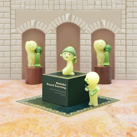 Three creatively posed companions, glowing in the dark, surround a box labeled "Smiski Museum Series - Blind Box" on a stone floor with arched backgrounds. This scene captures the whimsical charm and mysterious allure characteristic of Smiski products.