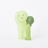 Two whimsical figures from the Smiski Museum Series - Blind Box by Smiski bring imagination to life: a small green humanoid with a surprised expression embraced by an octopus-like creature. These smooth, plastic companions make a delightful addition to any collection.