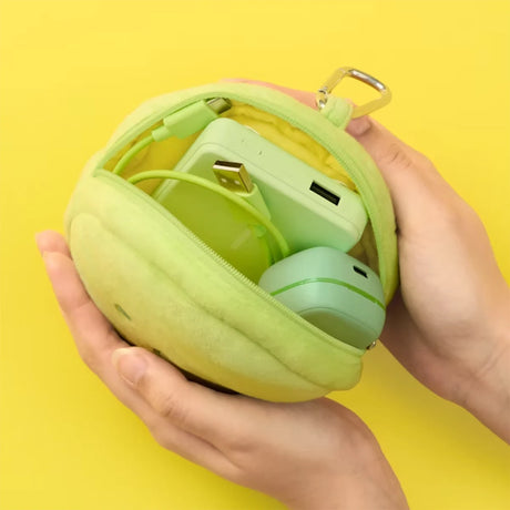 Person holding open small light green plush pouch showing charging cables and power bank inside