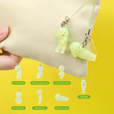Two pale green character keychain charms on a beige strap with icon diagram