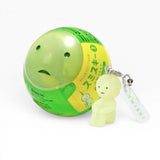 Smiski-style figure keychain attached to a green ball charm