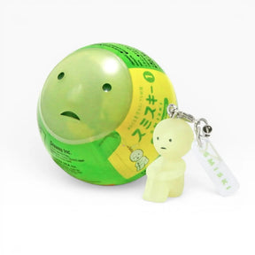 Smiski-style figure keychain attached to a green ball charm