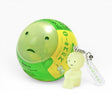 Smiski-style figure keychain attached to a green ball charm