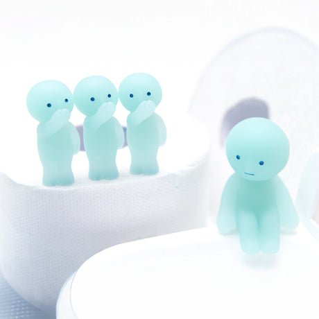 A group of four teal figures from the Smiski Toilet Series - Blind Box by Smiski stand together while one sits apart, each featuring simple facial expressions, bringing a whimsical touch to any display.