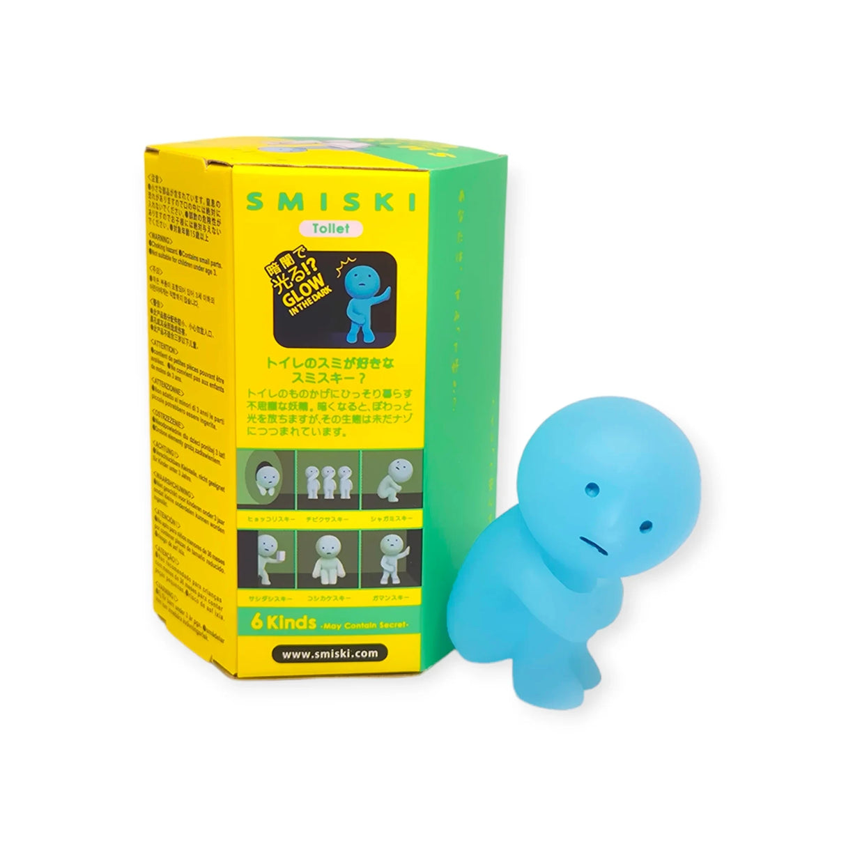 The Smiski Toilet Series - Blind Box by Smiski is accompanied by a green and yellow box displaying product information and images. This mini figure collectible is part of an enchanting collection of glow-in-the-dark figures.