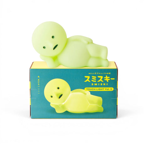 Smiski Touch Light lounging figurine, light-green glow, lying on side