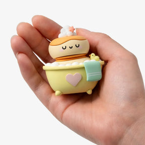 Yellow bath-themed blind box toy figure with heart motif and teal hand