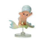 Kewpie blind box figurine: baby in teal swimsuit sitting on winged leaf stand