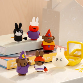 Assorted rabbit character figurines in different outfits on a display surface