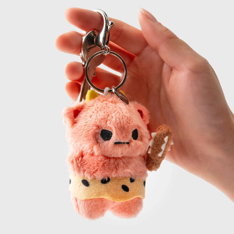 Hand holding Smoko Roni Oni plush keychain with pink demon character and small club, gallery image one