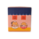 The box, marked with "Smoko Tayto Potato Ramen Blind Box," features playful cartoon designs of adorable characters in bowls. Dive into the surprise of discovering delightful vinyl figures from Smoko's collection inside.