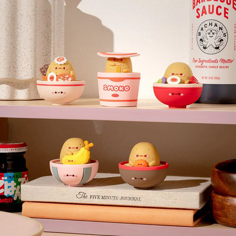 The adorable Smoko Tayto Potato Ramen Blind Box vinyl figures are displayed on shelves alongside various condiments and jars.