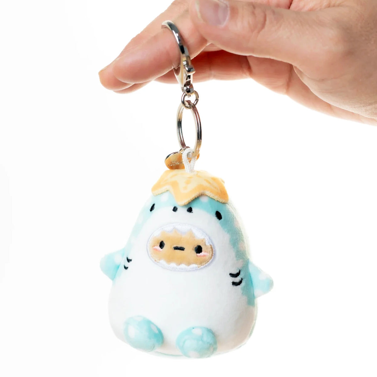 Whale shark plush bag charm on metal keyring, held in hand