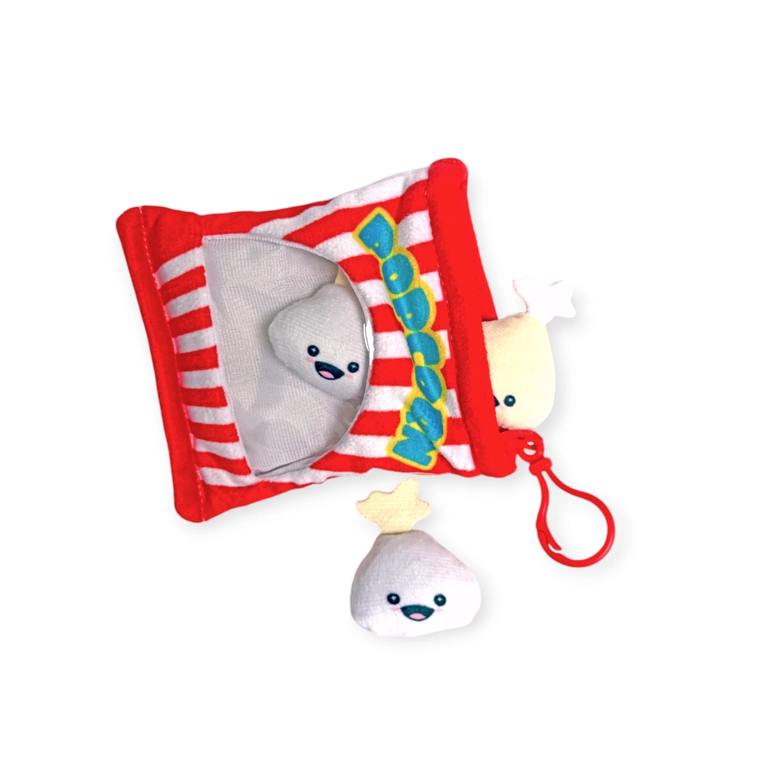 The Snack Bites Bag Charm by Bensons is a plush toy set that looks like a popcorn bag and includes two smiling popcorn pieces. One piece is outside the bag with a red clip for easy attachment, adding playful snack style to any collection.