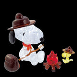 The Snoopy Camp 3D Crystal Puzzle features crystal figurines of a dog and bird in hats enjoying a camping moment by the glow of an LED campfire. The dog playfully holds a stick with a marshmallow, embodying delightful charm.