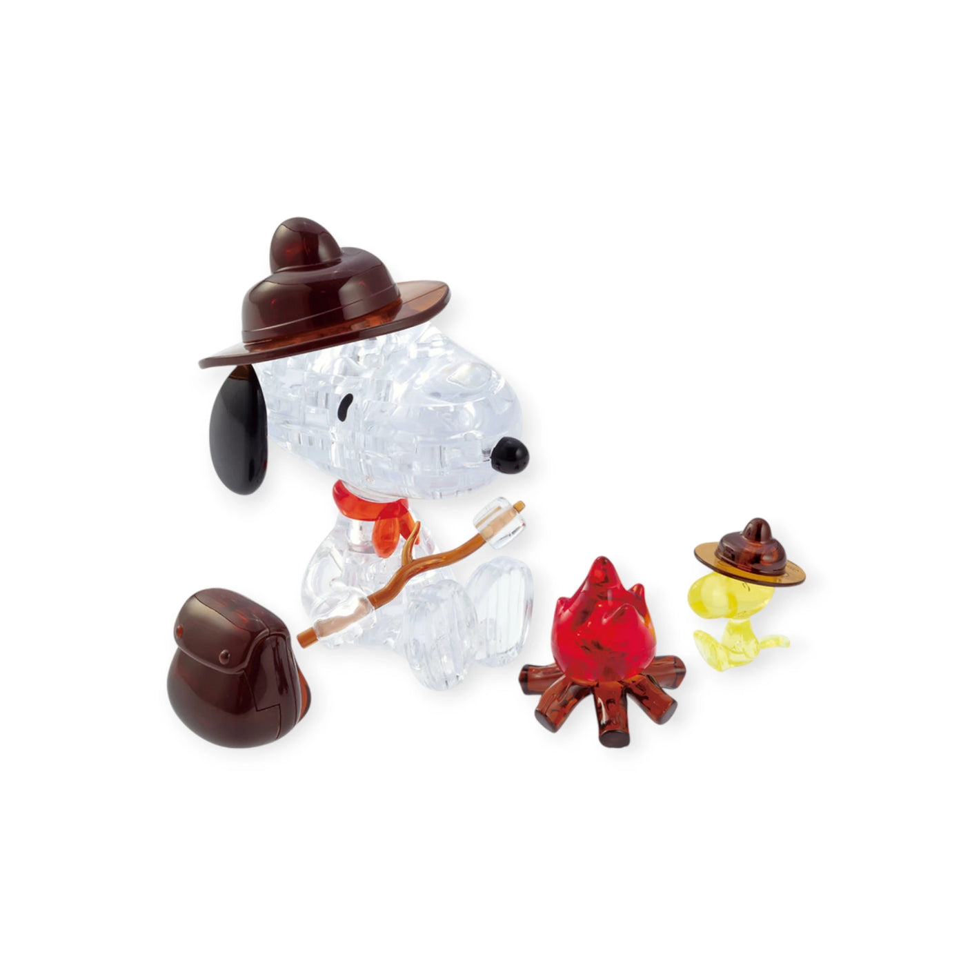 A clear Snoopy Camp 3D Crystal Puzzle figurine of a dog in a brown hat sits with a stick and backpack by a red campfire. A small yellow bird in its hat watches near the LED light, perfectly capturing a charming camping scene.