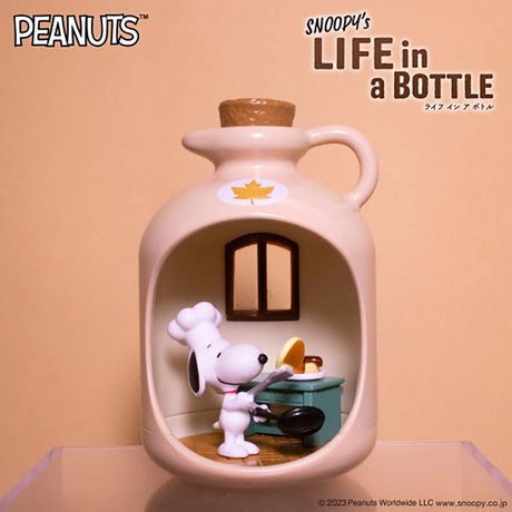 Miniature ceramic bottle with cork displaying Snoopy figurine cooking on stove inside cozy kitchen scene