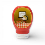 Red sauce bottle figurine featuring Snoopy as Flying Ace with pilot helmet and scarf inside a cozy diner scene