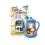 Miniature blue teapot figurine with Snoopy and Woodstock inside next to packaging featuring washing machine design