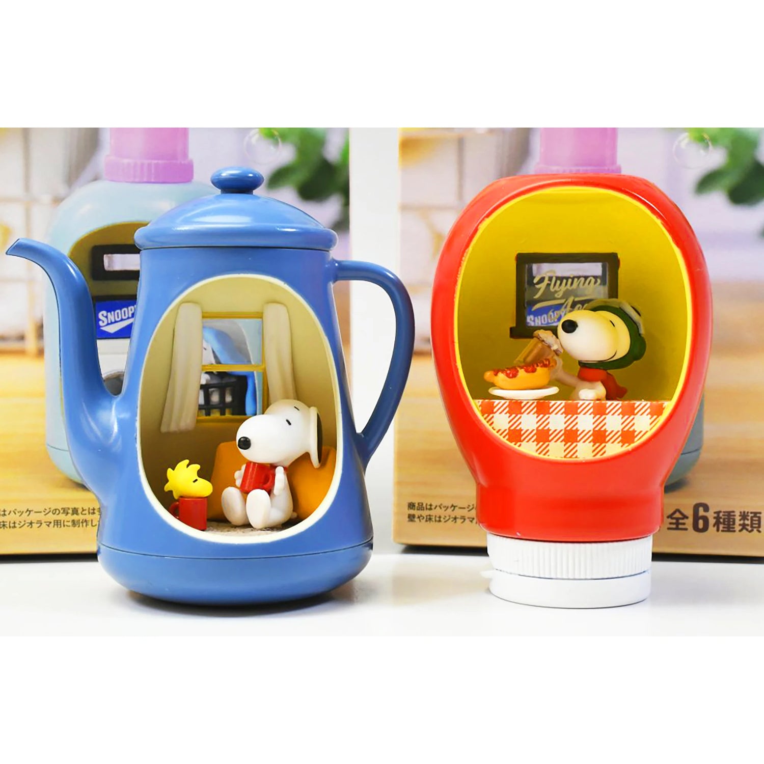 Miniature blue teapot and red bottle cap scenes featuring Snoopy and Woodstock in cozy diner settings