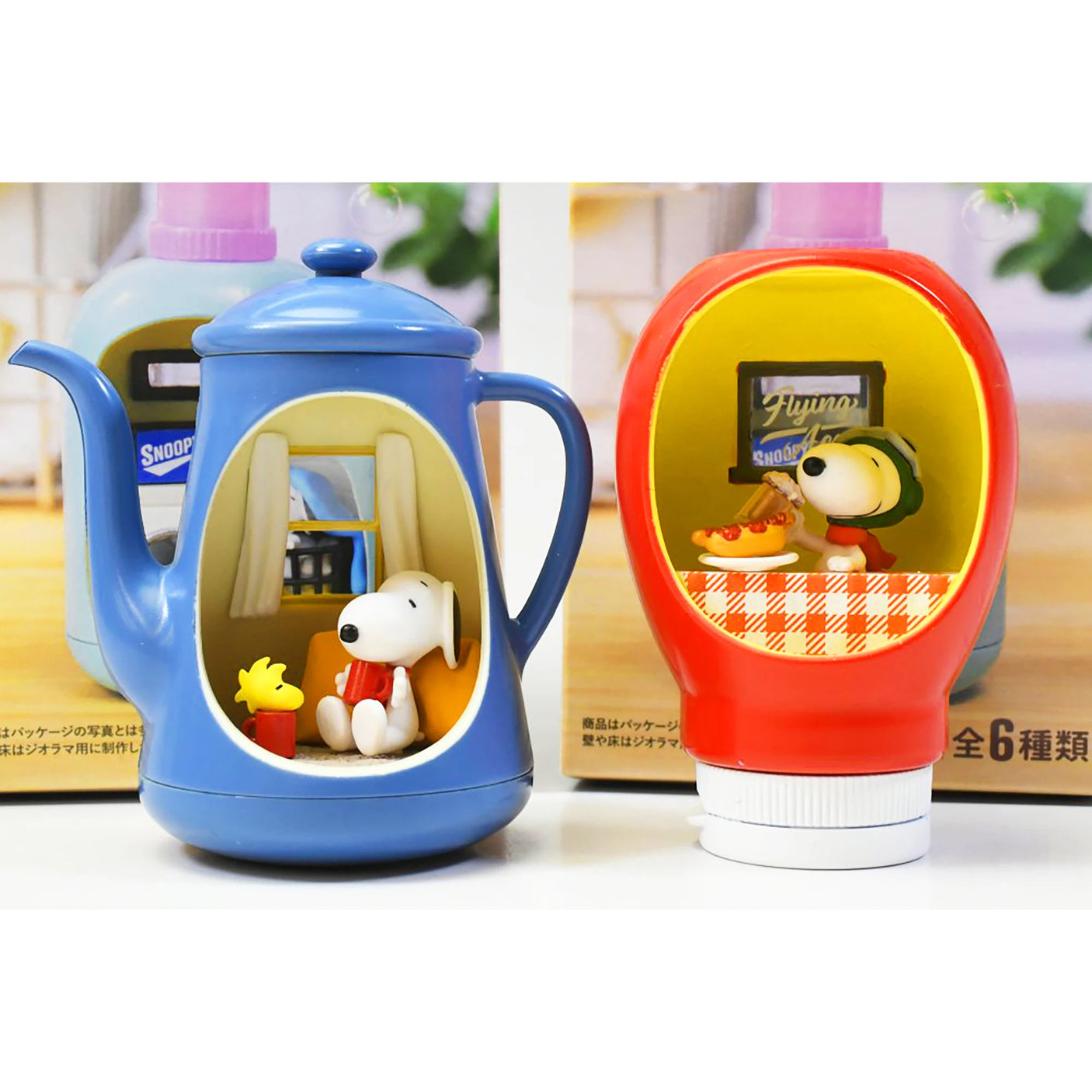 Miniature blue teapot and red bottle cap scenes featuring Snoopy and Woodstock in cozy diner settings
