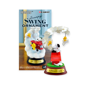 Snoopy on red doghouse swinging with Woodstock figures and white paper scrolls on green and brown base labeled Literary Ace