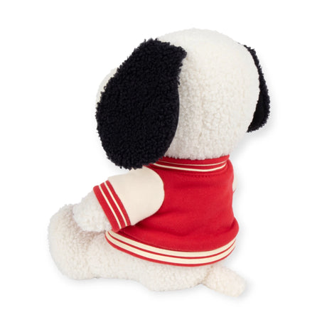 This Snoopy Plush Varsity Jacket 22cm - Limited Edition, part of the Peanuts Collection, showcases endearing black ears and a stylish red and white varsity jacket. As it sits facing away, it exudes charm from every angle.