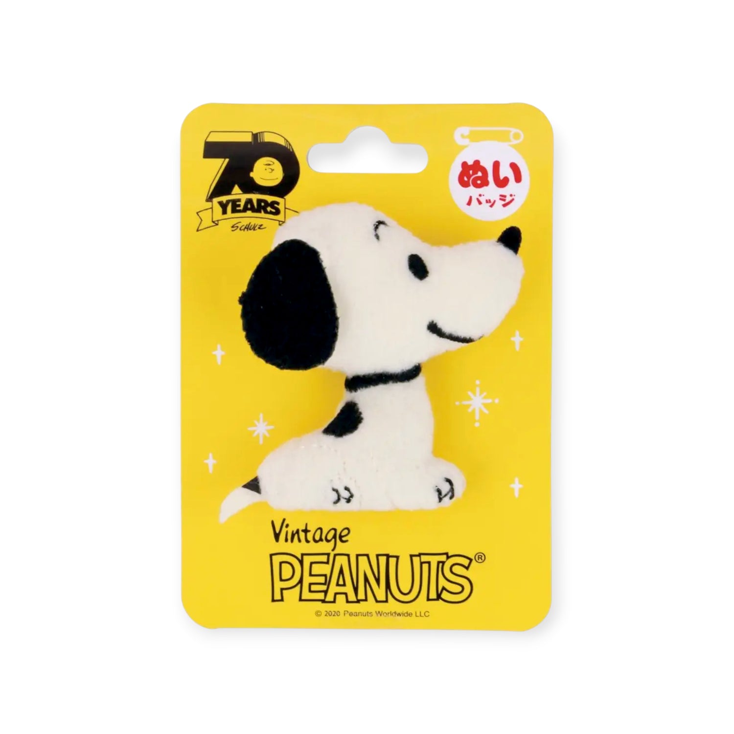 The Snoopy Vintage Plush Pin by Snoopy features vintage Peanuts branding and comes displayed on a yellow backing card to celebrate the 70th anniversary.