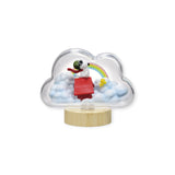 The Re-Ment Snoopy Blind Box - Weather Terrarium features a figure of Snoopy in a red airplane, enclosed in a cloud-shaped display complete with a rainbow and fluffy white clouds, evoking the charm of a whimsical weather terrarium.