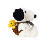 The Snoopy Plush Woodstock Backpack - 20cm showcases an endearing white dog with black ears and nose, sitting playfully with a small yellow bird in its backpack. Perfect for eco-conscious collectors!