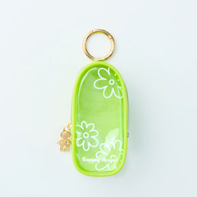 Green translucent Sonny Angel My Bestie Case with white floral print and gold-tone zipper pull, front gallery view one