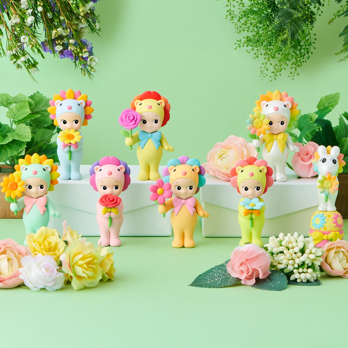 Eight vibrant Sonny Angel Flower Gift Series figurines by Sonny Angel stand on a green surface with floral accents—perfect as a flower gift or an eye-catching Blind Box surprise.