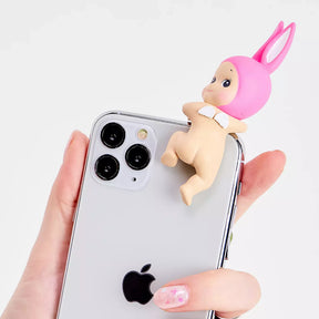 Pink bunny mini figurine on back of a smartphone in clear case