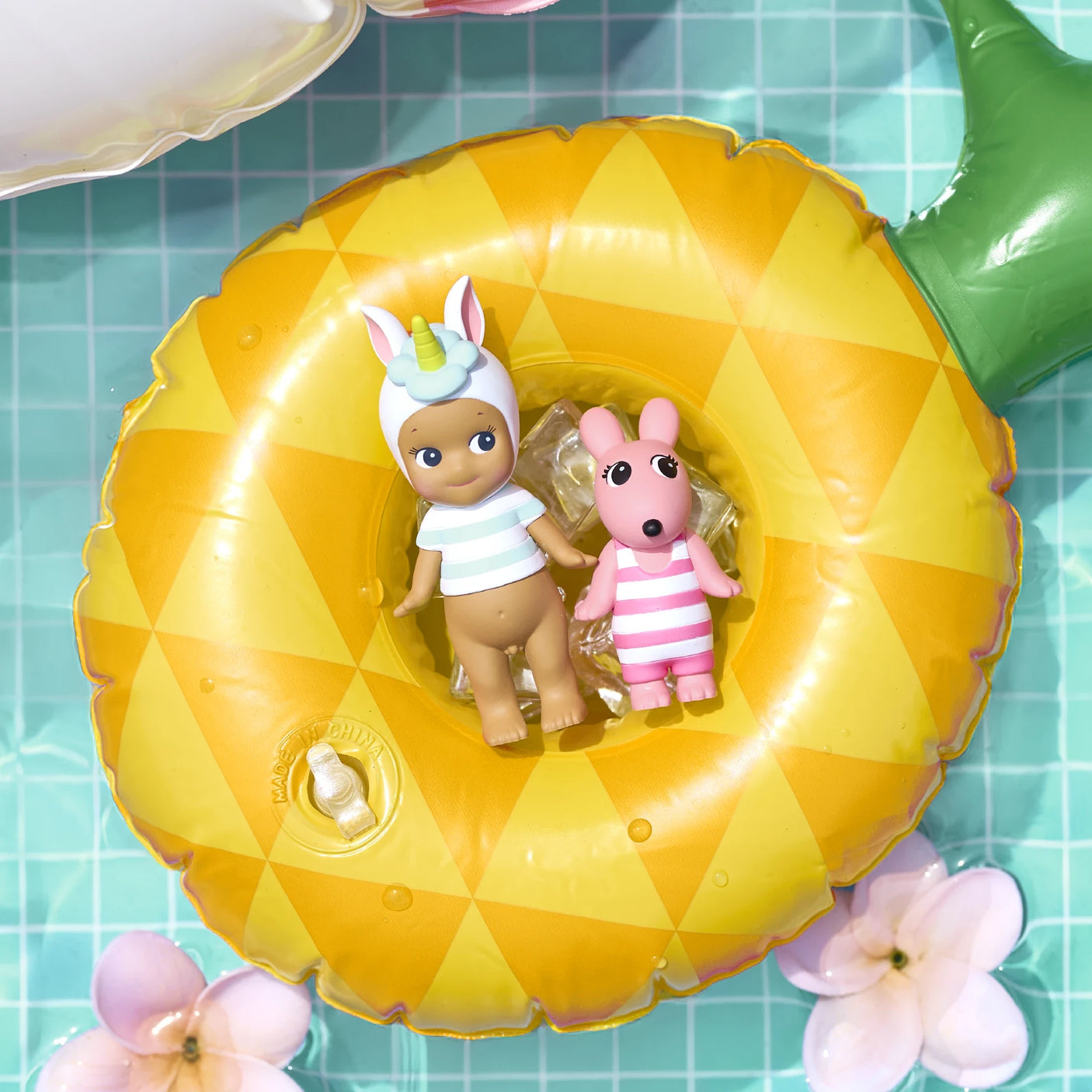 Sonny Angel Summer Vacation Sun Kissed figures inside yellow pool float ring