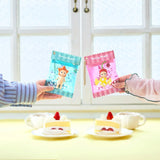Blue mini candy pouch case with chain held next to pink case